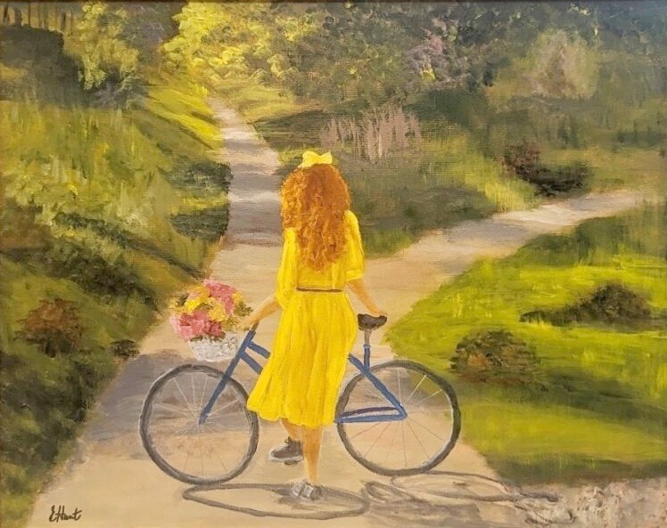 painting of a young girl with long reddish hair. She's wearing a longish belted yellow dress with a yellow bow in her hair and dark sneakers. Her back is to us and she's standing with her bicycle facing a path that forks in front of her. The area is grassy and full of tress which create spots of shade